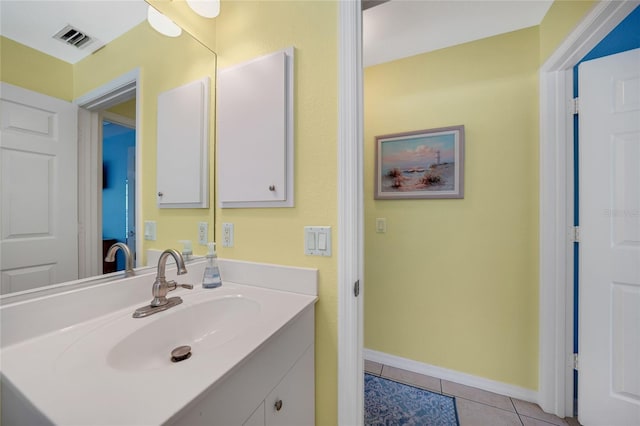 bathroom with tile patterned floors and vanity