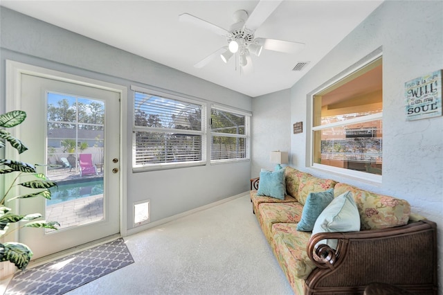 sitting room featuring carpet flooring and ceiling fan