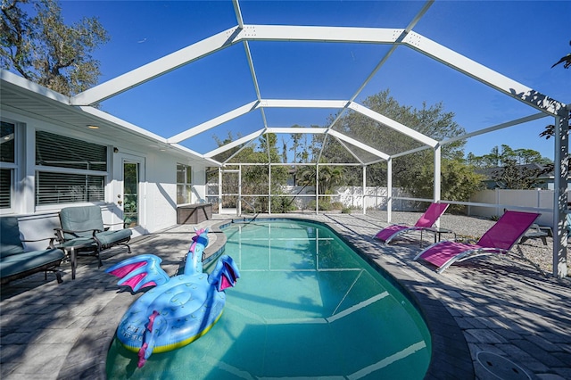 view of swimming pool with a lanai and a patio area