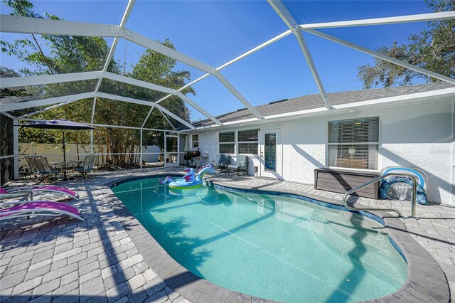 view of pool featuring a lanai and a patio