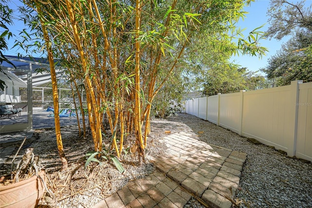 view of yard featuring a patio area and a lanai