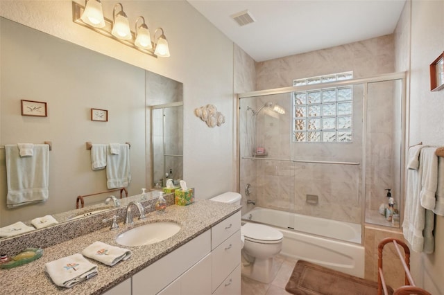 full bathroom featuring toilet, combined bath / shower with glass door, tile patterned flooring, and vanity