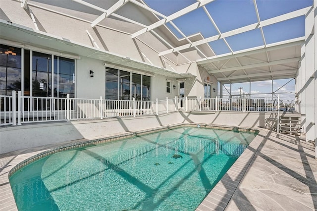 view of swimming pool featuring a lanai and a patio area