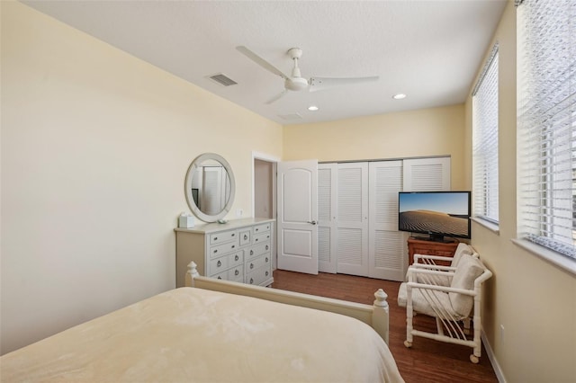 bedroom featuring ceiling fan, a closet, and hardwood / wood-style flooring