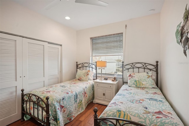 bedroom featuring ceiling fan, dark hardwood / wood-style floors, and a closet