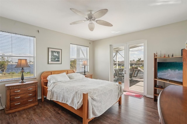 bedroom featuring ceiling fan, access to exterior, dark hardwood / wood-style flooring, and multiple windows