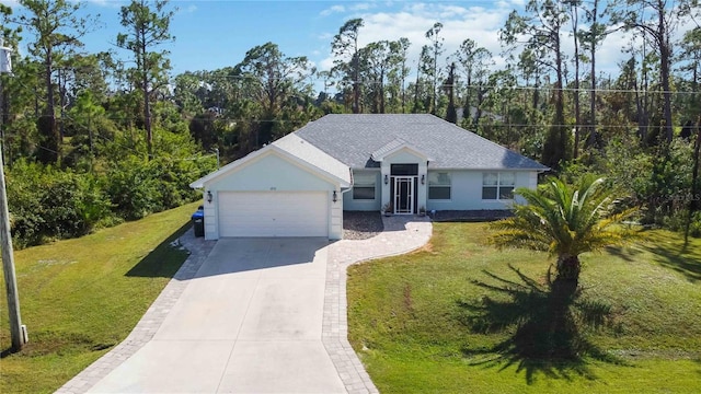 view of front of house with a garage and a front lawn