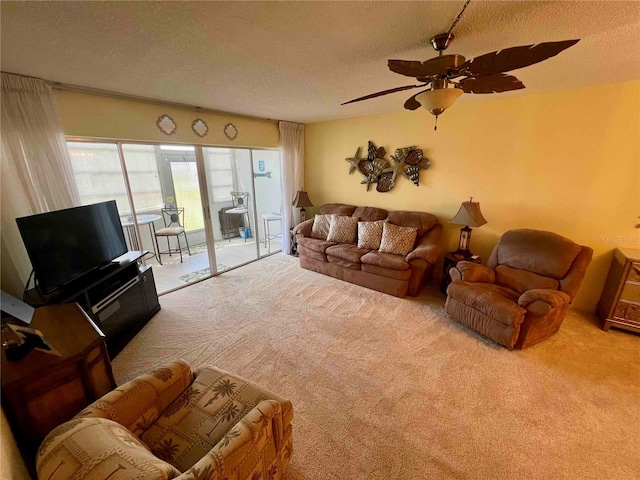 carpeted living room with ceiling fan and a textured ceiling