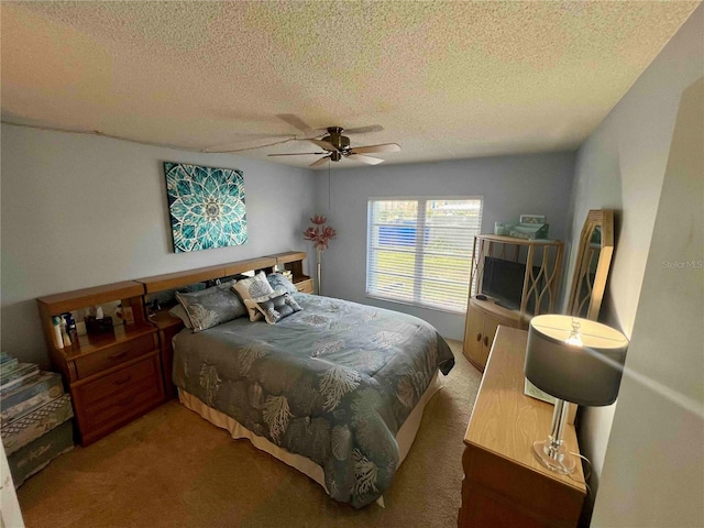 carpeted bedroom featuring a textured ceiling and ceiling fan