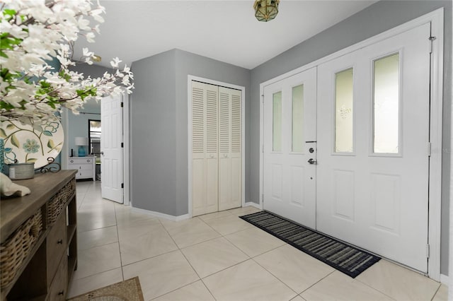 foyer entrance with light tile patterned floors