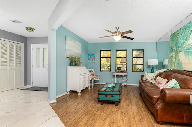 living room with light hardwood / wood-style floors and ceiling fan