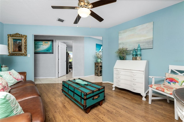 living room featuring light hardwood / wood-style flooring and ceiling fan