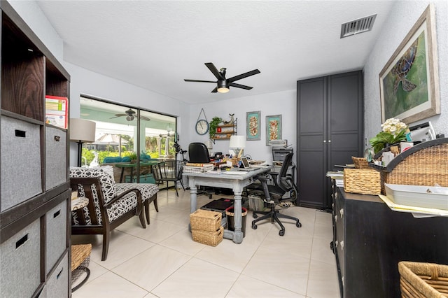 office featuring ceiling fan, a textured ceiling, and light tile patterned floors