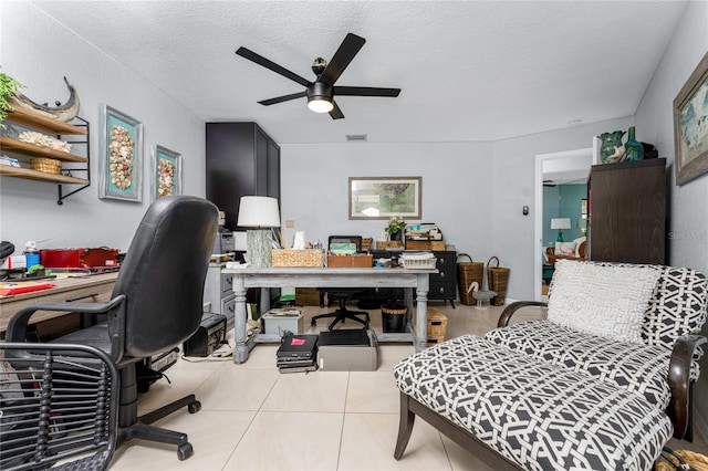 tiled office featuring a textured ceiling and ceiling fan