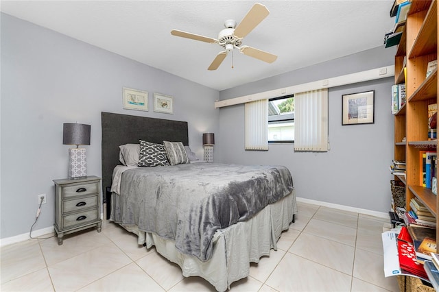 bedroom with ceiling fan and light tile patterned flooring