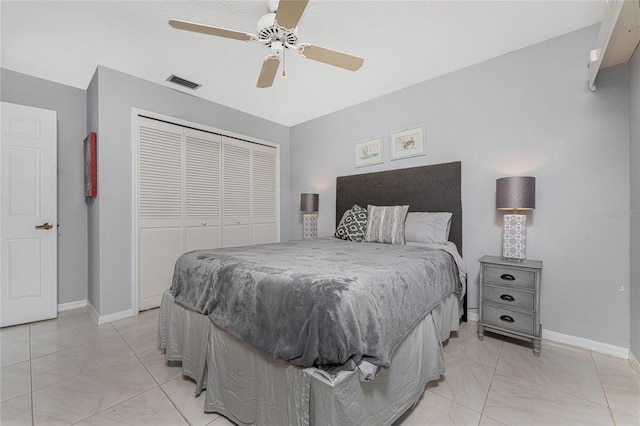 bedroom with a closet, ceiling fan, and a textured ceiling