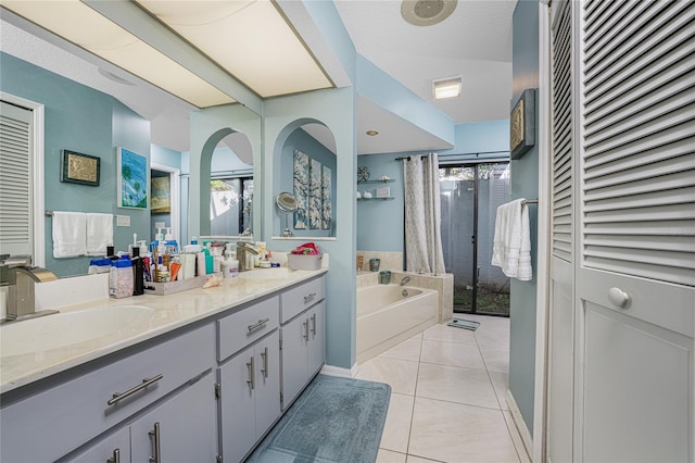 bathroom with vanity, a textured ceiling, independent shower and bath, and tile patterned flooring