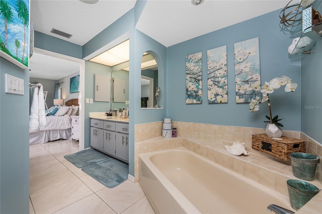 bathroom featuring vanity, a bathtub, and tile patterned floors