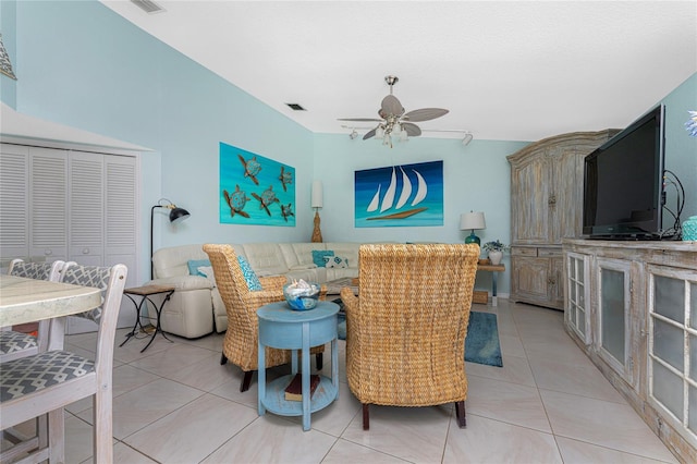 tiled living room with ceiling fan