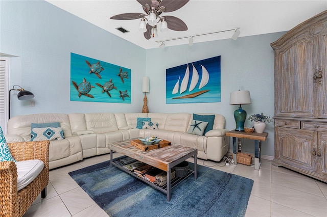 living room featuring track lighting, ceiling fan, and light tile patterned floors