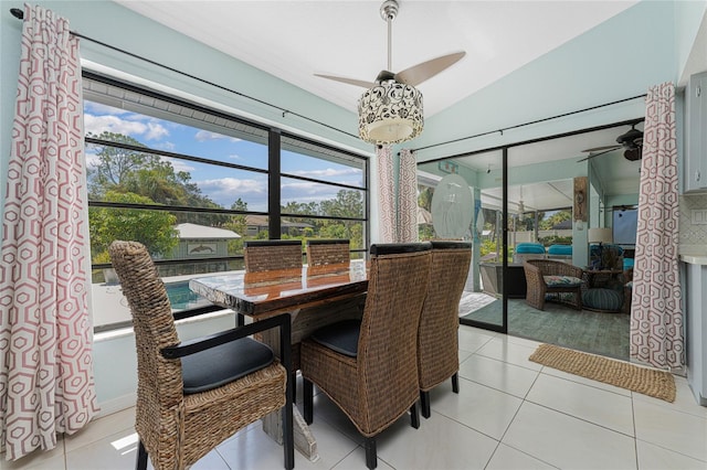 dining room with vaulted ceiling, light tile patterned flooring, and ceiling fan