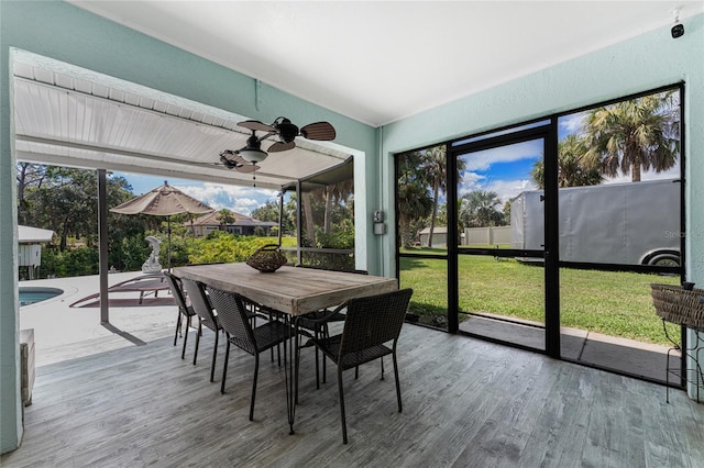 sunroom featuring ceiling fan