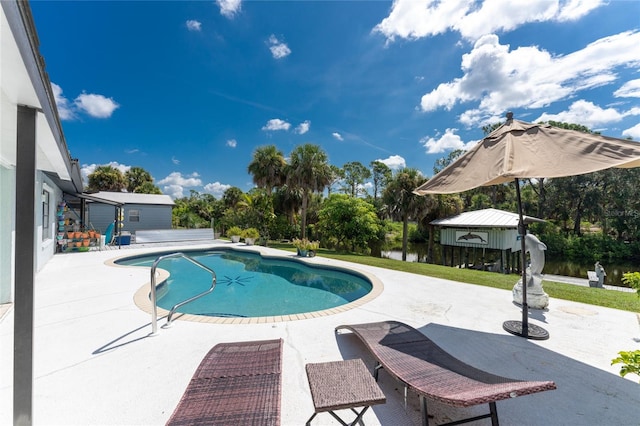 view of pool featuring a patio and a water view