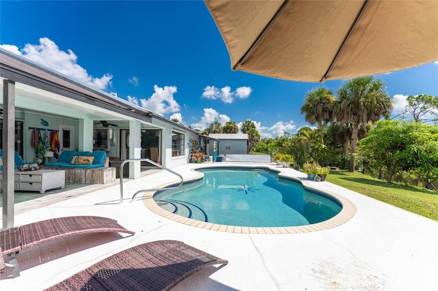 view of swimming pool with a patio, ceiling fan, and an outdoor hangout area