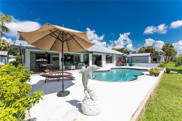 view of pool with a patio and a yard