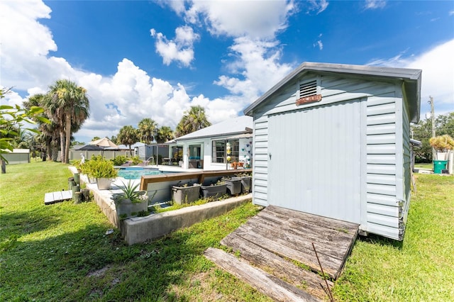 rear view of property with a shed and a yard