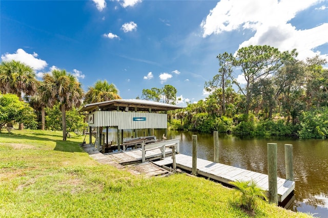 dock area with a water view and a lawn