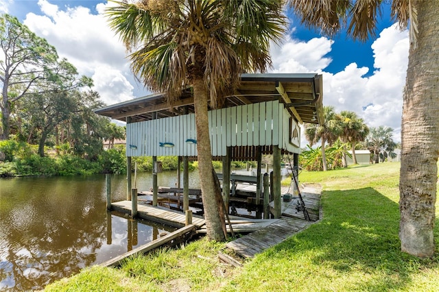 dock area featuring a lawn and a water view