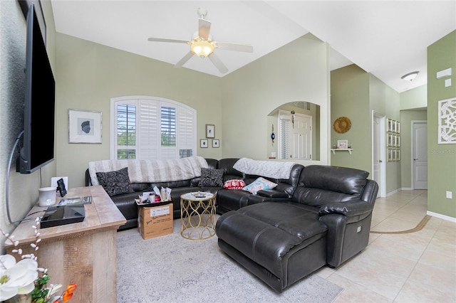 living room featuring vaulted ceiling, light tile patterned floors, and ceiling fan