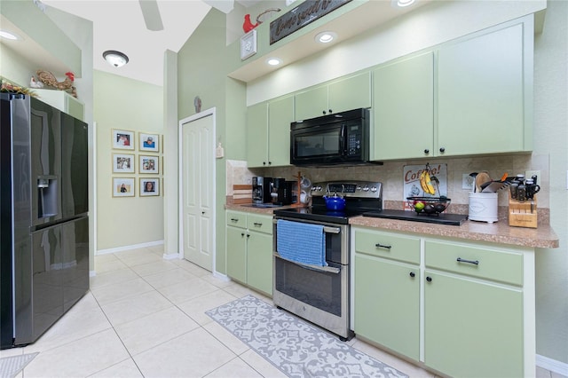 kitchen featuring green cabinetry, black appliances, and backsplash