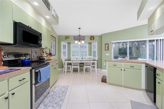 kitchen with green cabinets, black appliances, light tile patterned floors, lofted ceiling, and pendant lighting