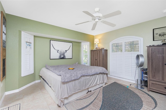 tiled bedroom featuring ceiling fan