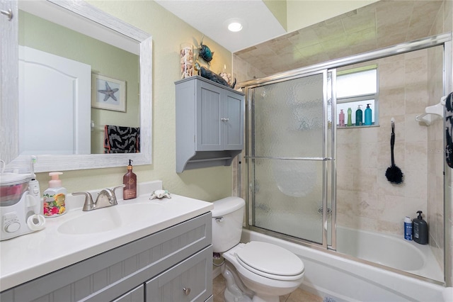 full bathroom with toilet, vanity, tile patterned flooring, and shower / bath combination with glass door