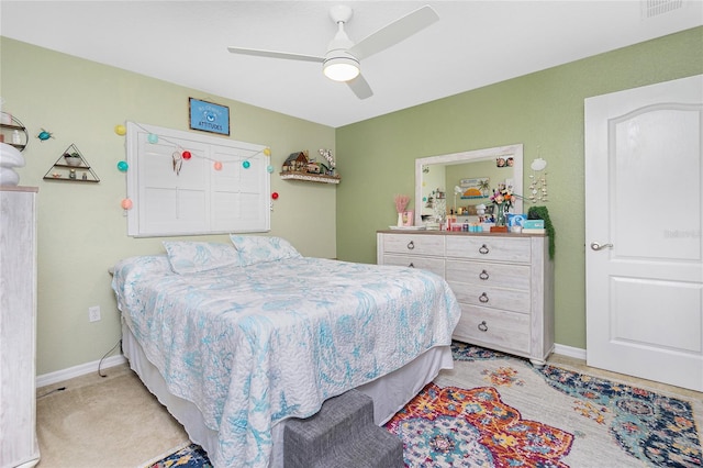 bedroom with ceiling fan and light carpet