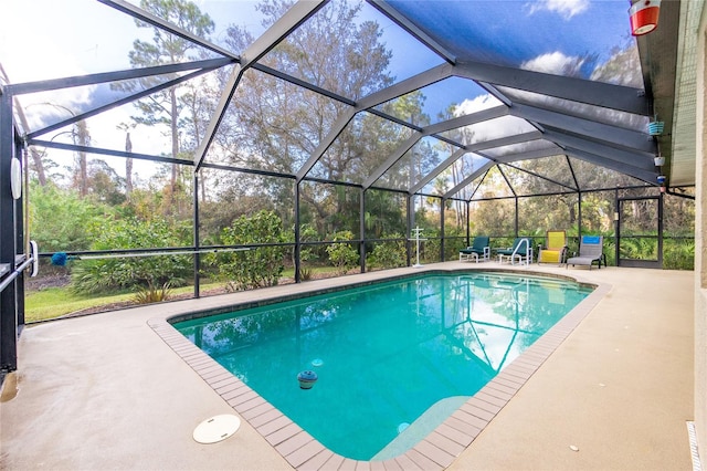 view of pool with a lanai and a patio