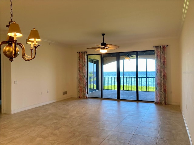 spare room with ornamental molding, ceiling fan with notable chandelier, a water view, and light tile patterned floors