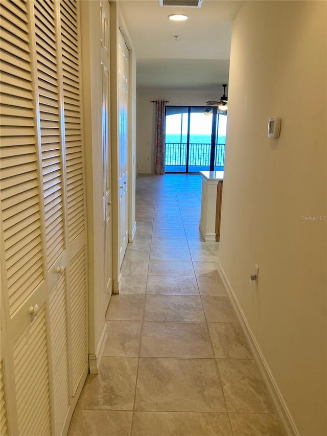 corridor with light tile patterned floors