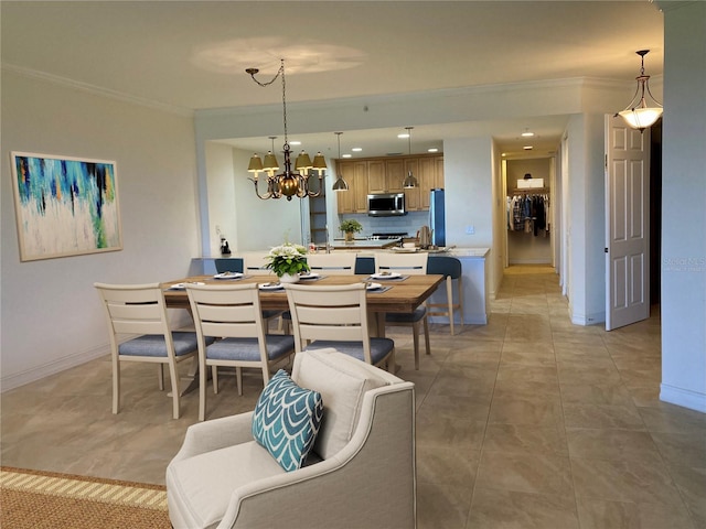 dining room with a notable chandelier, light tile patterned flooring, and crown molding