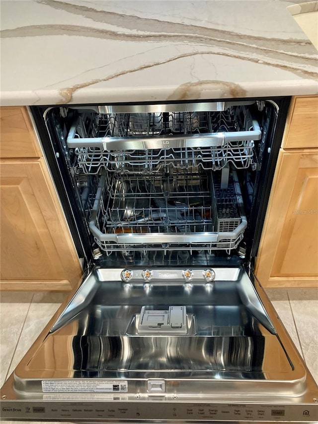 interior details featuring decorative backsplash and dishwashing machine