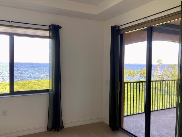 carpeted spare room with a water view