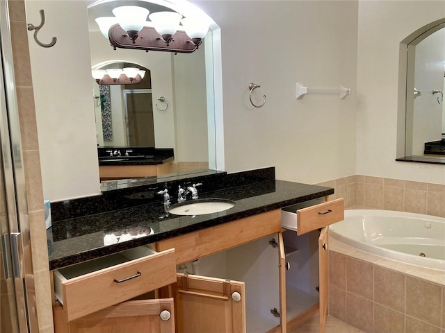 bathroom with vanity and separate shower and tub