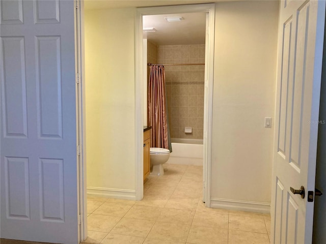 bathroom featuring toilet, tile patterned floors, and shower / bathtub combination with curtain