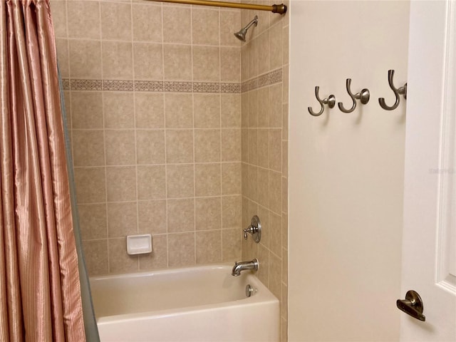 bathroom with shower / bath combo with shower curtain