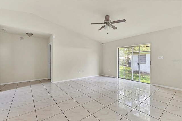 tiled empty room featuring ceiling fan and lofted ceiling