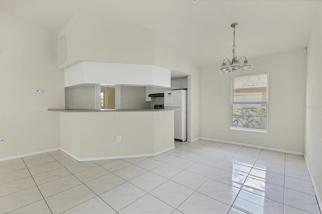 interior space featuring light tile patterned floors, vaulted ceiling, and a notable chandelier