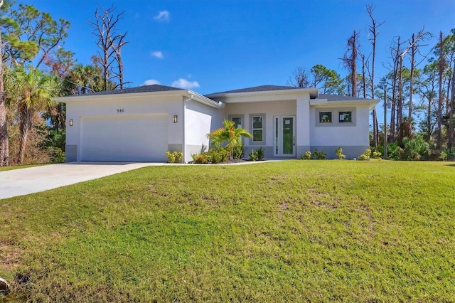 view of front of home featuring a front yard and a garage